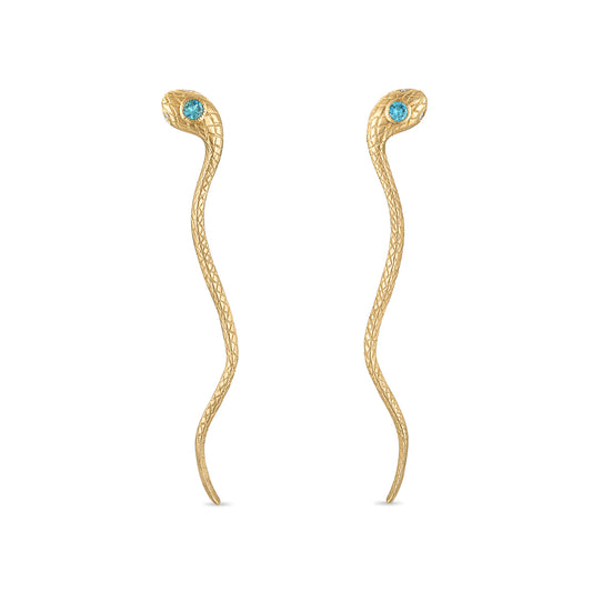 A pair of 14k gold snake earrings with engraved scales, milgrain bezel set teal green sapphire head stones and diamond eye stones. The earrings are single piece snake head post back studs with the long tails dropping down.