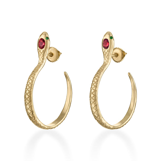 Gold snake hoop earrings with red gemstones on a white background